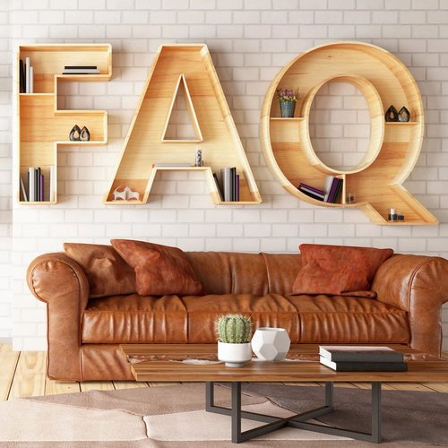 FAQ wood sign on wall in living room with a brown couch and light hardwood flooring  from Butler Floors in the Austin, TX area